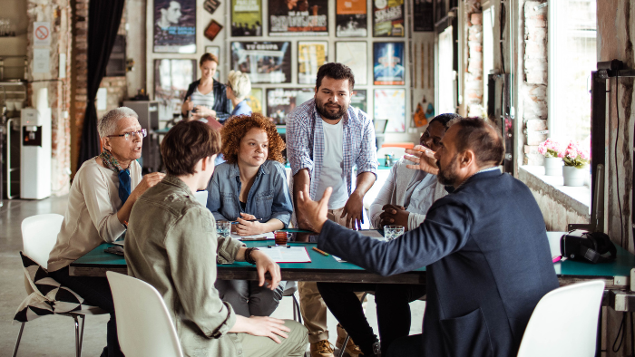 A group of people work together in an office setting.